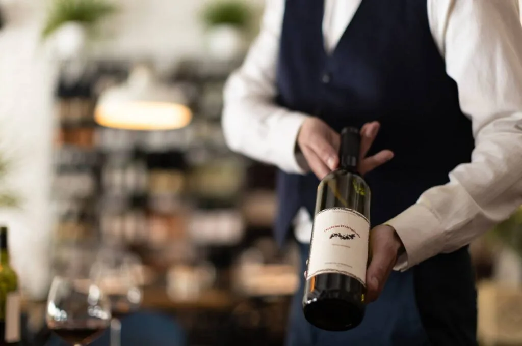 Sommelier apresentando vinho ao cliente